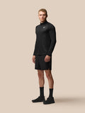 Male model wearing black Adapt Training 1/4 Zip Top with geometric pattern and Castore branding on chest and back
