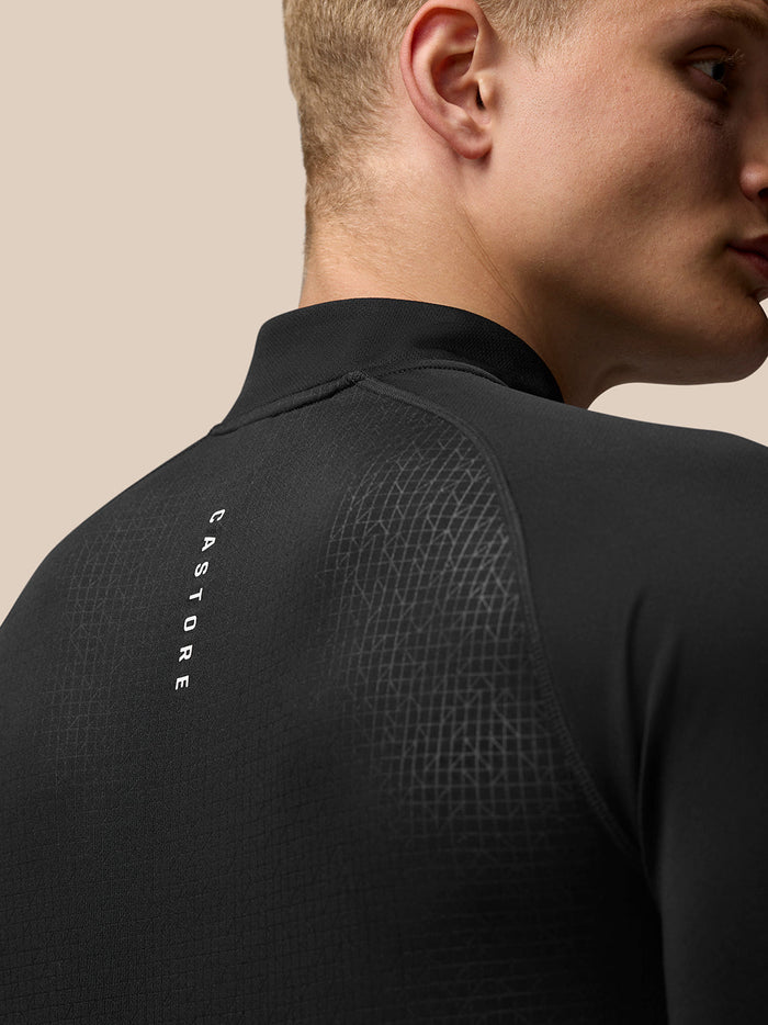 Back view of black Adapt Training 1/4 Zip Top with geometric pattern and vertical Castore branding along the back