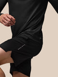 Back view of black Adapt Training long sleeve top with all over geometric texture and Aertek branding at lower back