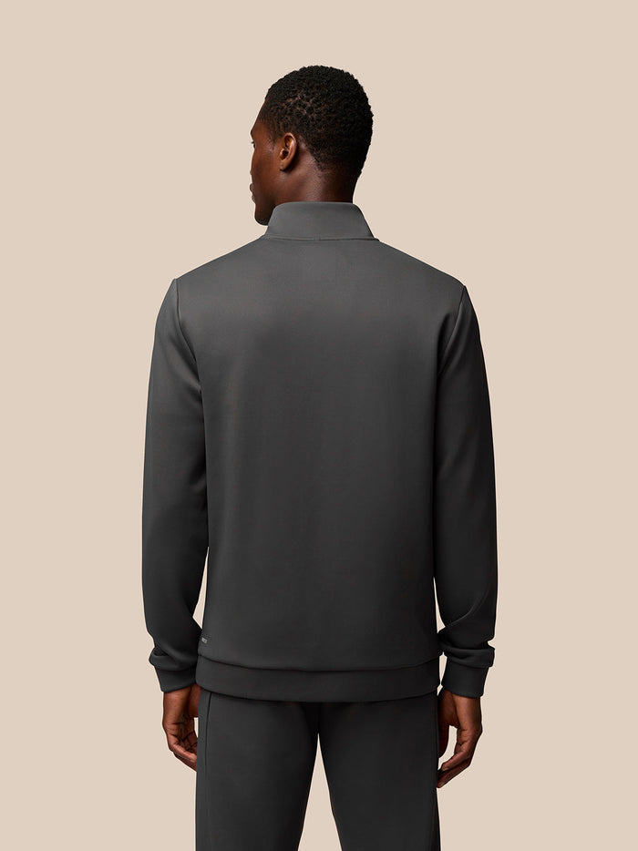 Back view of male model in charcoal Castore Flex Lifestyle 1/4 Zip top