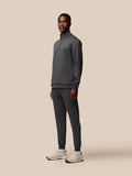 Male model in charcoal Flex Lifestyle 1/4 Zip top with matching joggers and sneakers