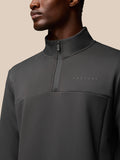 Close up of a man wearing a charcoal Castore Flex Quarter Zip top with a high collar and front zipper