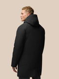 Back view of a person in black longline hooded jacket with hood and subtle Castore branding.