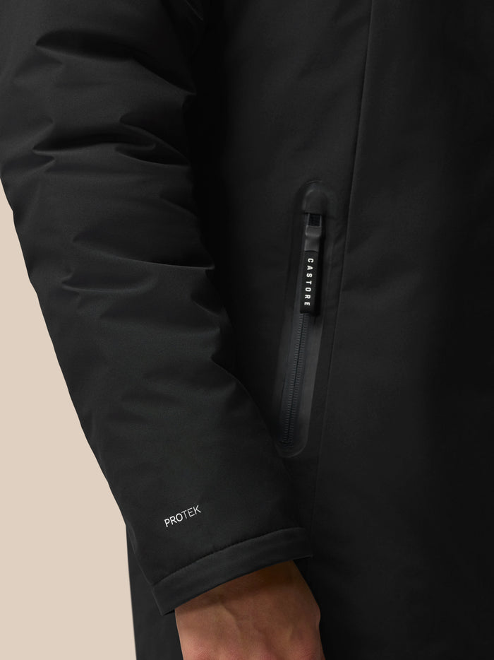 Center front zip on black jacket with a Castore branded zipper pull and ProTek branding on the sleeve