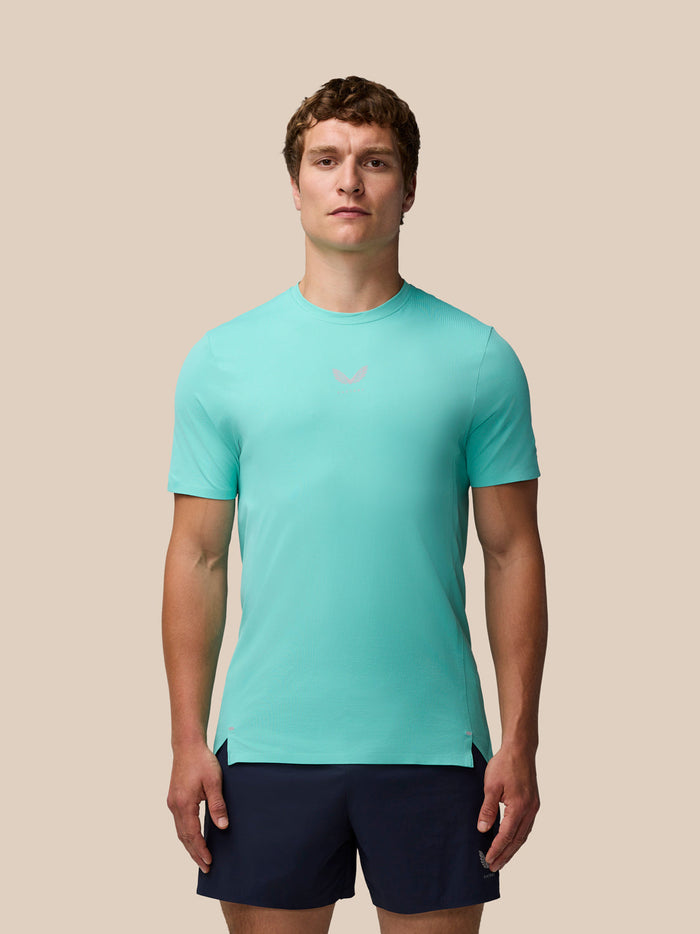 Male model in light aqua Zone Training T-Shirt with navy shorts facing forward