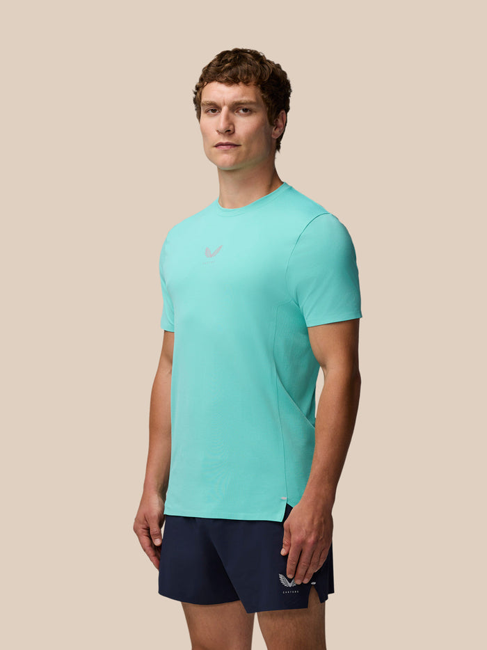 Front view of a man wearing Zone Training T-Shirt in light aqua with navy shorts