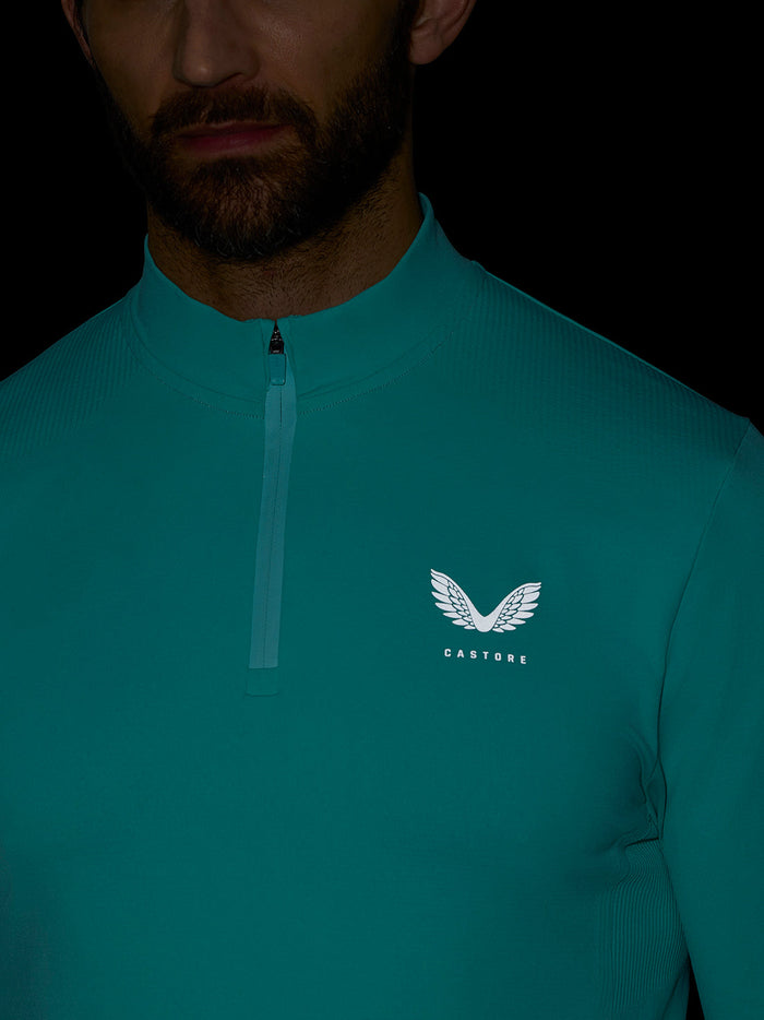 Chest close-up with white Castore logo and front zipper on light aqua Zone Training 1/4 Zip Top