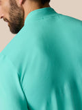 Back shoulder close-up showing ribbed ventilation panels on the light aqua Zone Training 1/4 Zip Top