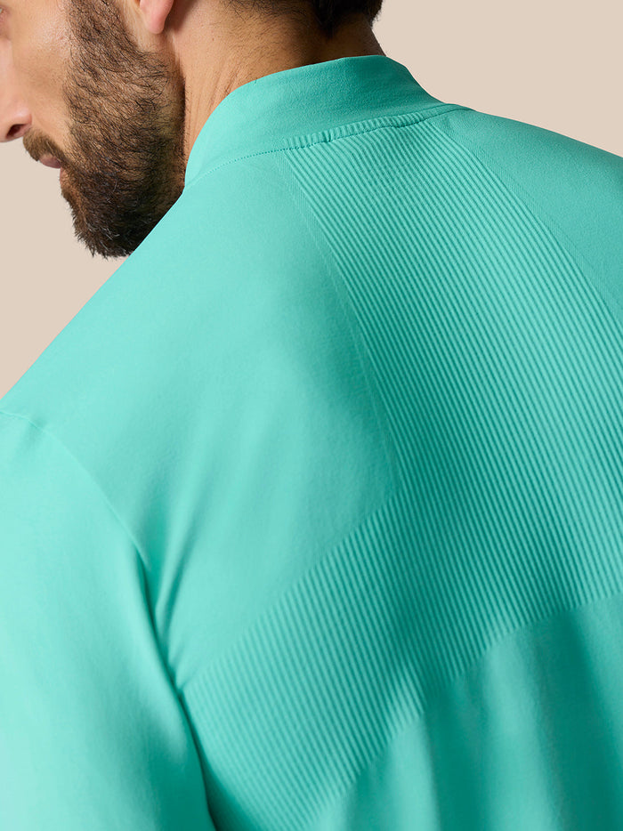 Back shoulder close-up showing ribbed ventilation panels on the light aqua Zone Training 1/4 Zip Top