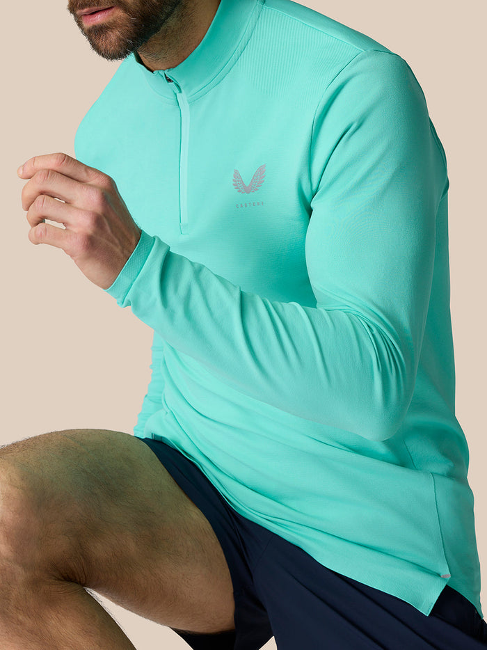Model wearing light aqua Zone Training 1/4 Zip Top with high neck and quarter zip