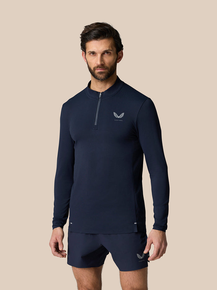 Male model in navy Zone Training 1/4 Zip Top with high neck, zip closure and logo on chest.