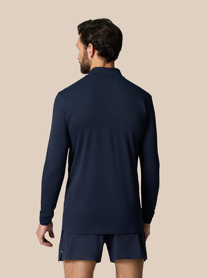 Back view of a man wearing the Zone Training 1/4 Zip Top in midnight navy with long sleeves and a dropped hem.