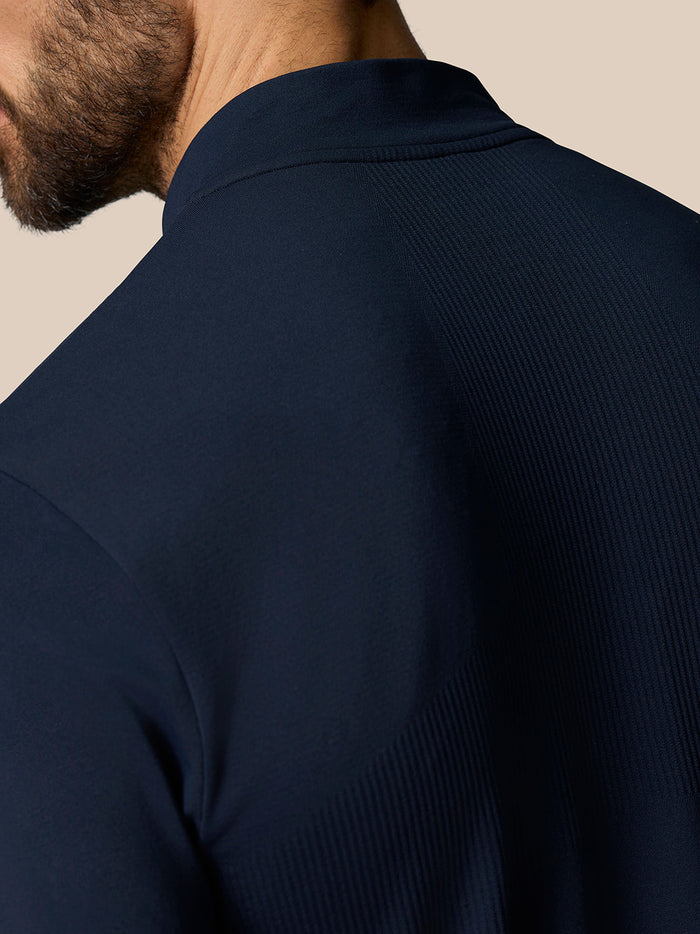 Close-up of navy Zone Training top shoulder showing ribbed ventilation panel and seam details.