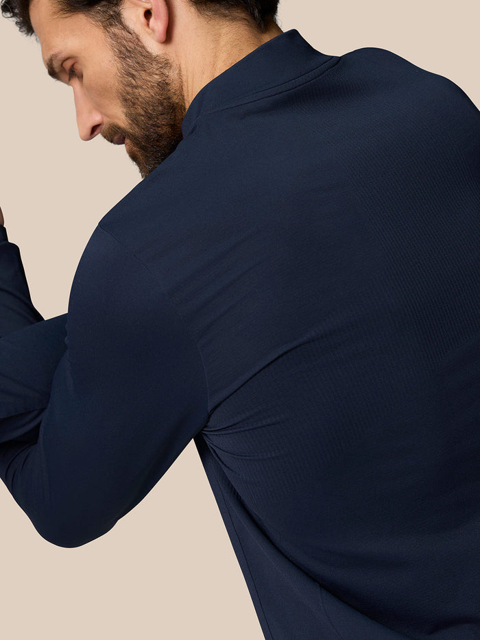 Back view of a man in Zone Training 1/4 Zip Top in midnight navy highlighting the fabric texture and shoulder seam