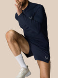 Male model wearing Zone Training 1/4 Zip Top in midnight navy kneeling to show the long sleeves and high neck with zip