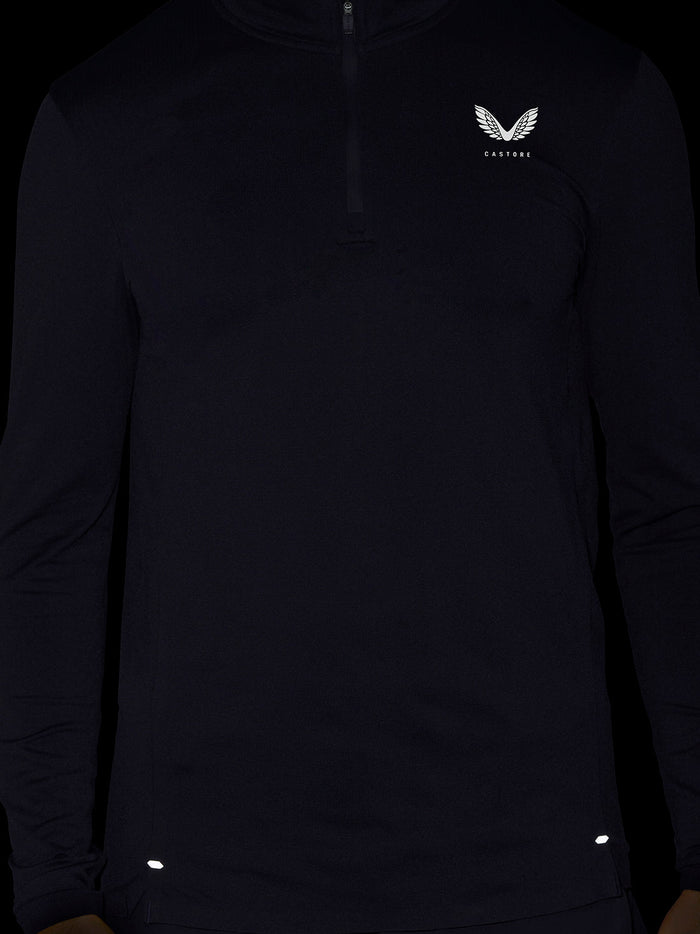Close up of a dark Zone Training 1/4 Zip Top with a small white crest on the chest and zip at the neck