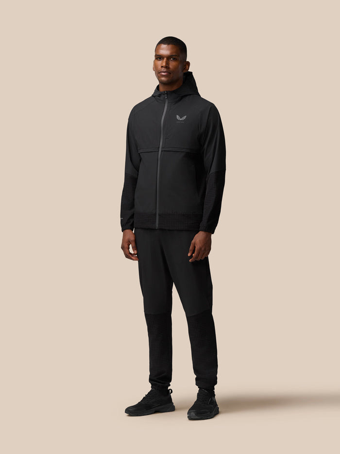 Rear view of male model in black Flex Winterised Woven Joggers with textured lower legs