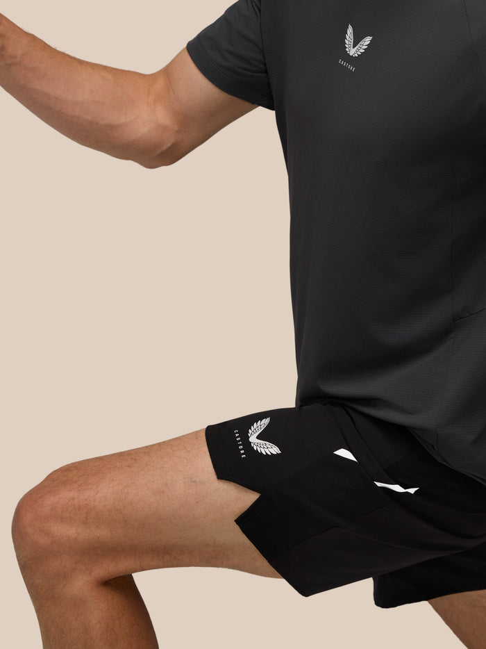 Close-up of a black Castore athletic shirt showing chest logo and a visible zipper