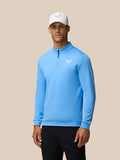 Male model wearing Castore Golf Club Classic 1/4 Zip Top in cool blue with funnel collar and left chest logo