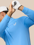 Model wearing Cool Blue Club Classic quarter zip top with white cap and gloves; Castore logo on left chest