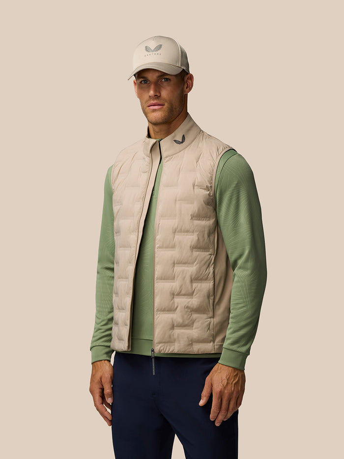Mushroom Golf Pinnacle gilet with quilted front and ProTek finish worn by a model on a neutral backdrop.