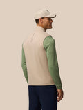 Back view of a man wearing Mushroom Golf Pinnacle lightweight hybrid gilet over a green long sleeve
