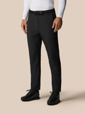 Front view of a male model wearing black Golf Pinnacle Winter Trousers with a black belt and golf shoes.