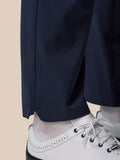 Close-up of navy Golf Pinnacle Winter Trouser leg hem over white golf shoes