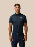 Male model wearing Golf Pinnacle Glow Polo in Midnight Navy with all over striped knit and left chest Castore logo.