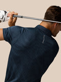 Back view of golfer wearing Midnight Navy Pinnacle Glow Polo with Castore branding along the back and a golf club held across the shoulders.