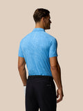 Back view of male model in a light blue glow printed polo displaying subtle fabric pattern