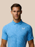 Male model wearing light blue Golf Club Glow Printed Polo with a white Castore logo on the chest