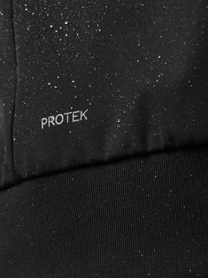 Close up of ProTek logo on black fabric with water droplets.