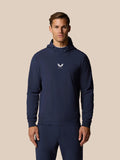 Man in midnight navy Pinnacle Performance Hoodie with hood and chest logo.