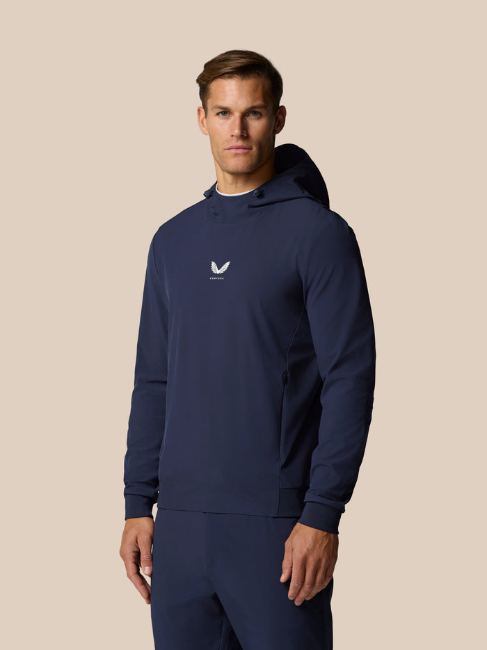 Male model wearing midnight navy Golf Pinnacle Performance Hoodie with front chest logo and hood.