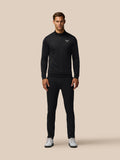 Full-body view of male model in black Golf Club Classic 1/4 Zip Debossed Top with all over print