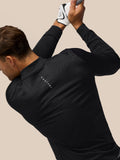 Back and left chest view of man wearing black all over print golf top with subtle pattern and Castore branding