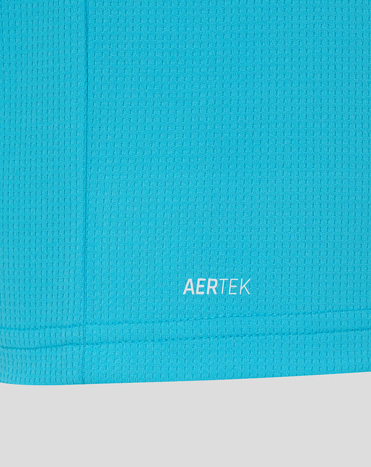 Close up of bright blue fabric near the hem showing AERTEK branding.