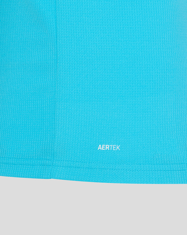 Close-up of bright blue ODI short sleeve shirt fabric with AERTEK branding at the hem