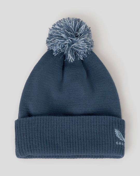 Blue bobble hat close-up showing ribbed cuff and embroidered Three Lions crest