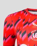 Front view of the Welsh Fire training T shirt with crest sponsor logos and Castore collar label on a red pink geometric print