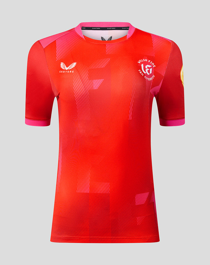 Welsh Fire women's 2026 short sleeve stretch jersey in red with pink trim, bold geometric pattern, crest and sponsor logos.