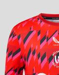 Shoulder close up of the red Welsh Fire training T shirt with bold geometric print and Castore branding at the neckline