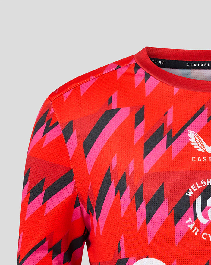 Shoulder close up of the red Welsh Fire training T shirt with bold geometric print and Castore branding at the neckline