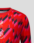 Close up of chest area on red Welsh Fire training T shirt displaying crest and geometric pattern