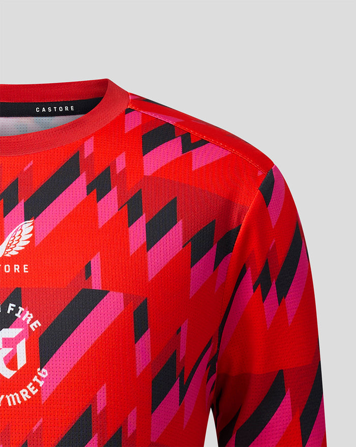 Close up of chest area on red Welsh Fire training T shirt displaying crest and geometric pattern