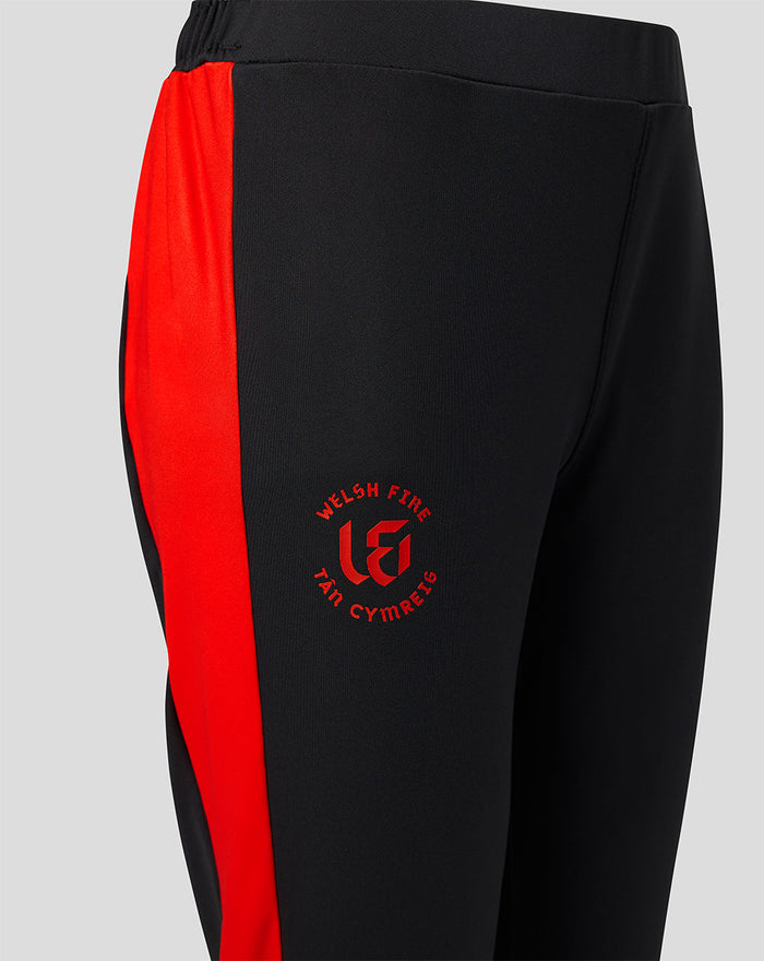 Close up of black pants showing red side stripe and Welsh Fire crest on the thigh