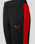 Black junior Welsh Fire pants with red side panel and Castore logo.
