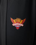 Close-up of the Sunrisers Leeds logo on black fabric of juniors pants