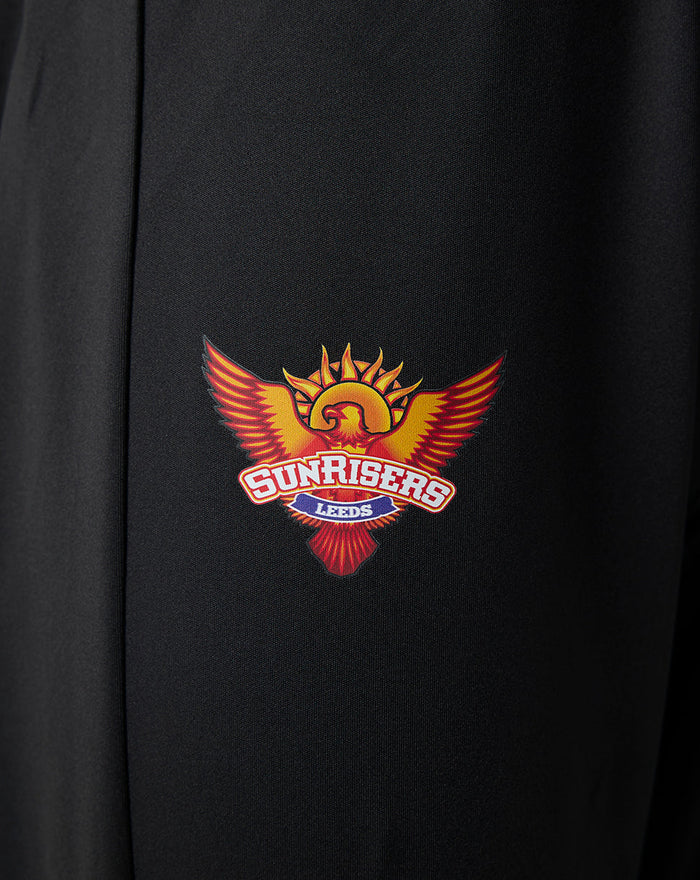 Close-up of the Sunrisers Leeds logo on black fabric of juniors pants